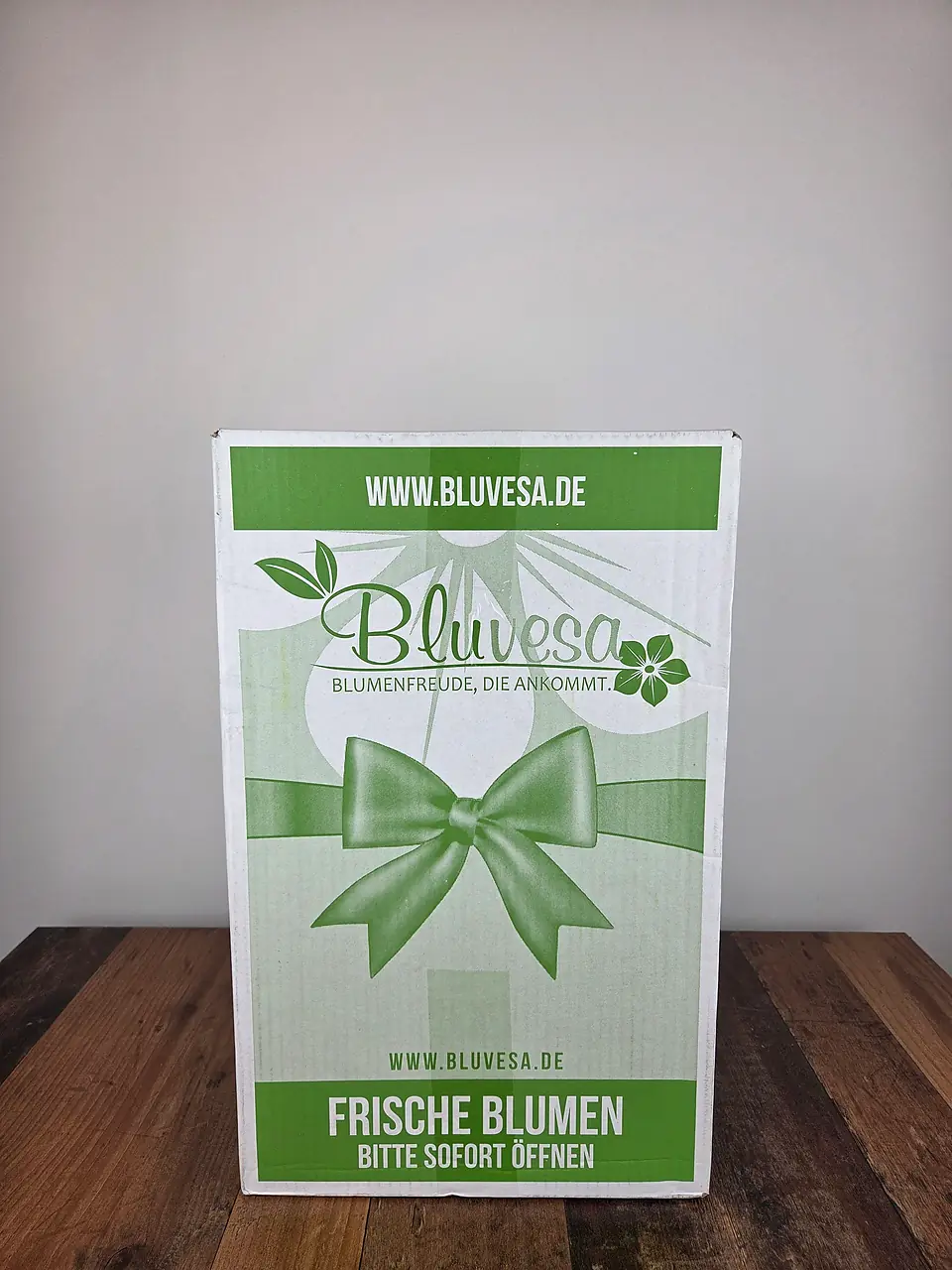 Bluvesa Versandkarton mit grünem Schleifen-Aufdruck und Hinweis Frische Blumen bitte sofort öffnen
